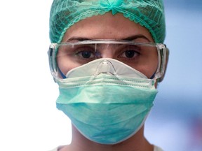 A medical worker wearing a protective mask and glasses, who treats patients suffering from coronavirus disease (COVID-19), is seen in an intensive care unit at the Oglio Po hospital in Cremona, Italy March 19, 2020.