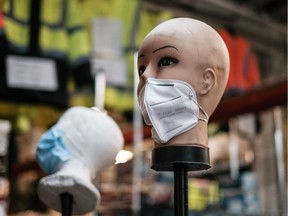 A mannequin displays disposable face masks.