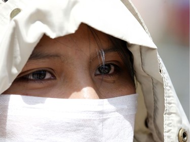 Mariluna Apaza, a stranded Peruvian passenger, talks with Reuters at the border line between Peru and Bolivia after Peru's government's announcement of border closure in a bid to slow the spread of the new coronavirus (COVID-19), in Desaguadero, Bolivia.