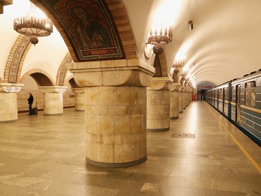 A passenger waits for the last train before metro shutdown amid coronavirus (COVID-19) concerns, at Zoloti Vorota station in central Kiev, Ukraine on Tuesday.