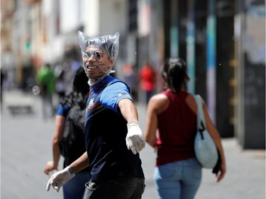 A man covers his face with a plastic bag in response to the spreading coronavirus (COVID-19) in Caracas, Venezuela March 14, 2020.
