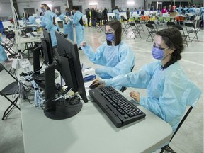 Public health workers  at the Brewer Arena testing location.