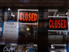 Temporary closed signage is seen at a store in Manhattan borough following the outbreak of COVID-19 in New York City March 15, 2020. (REUTERS/Jeenah Moon)