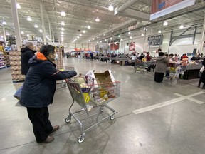 A man wearing a mask shops at Costco in Ottawa on Saturday.