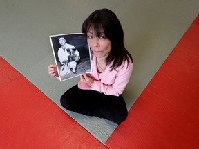 Tina Takahashi holds a photo of her late father Mas Takahash, who died Feb. 14. A celebration of his life was scheduled for April 5, but has been put off for travel reasons and attendance restrictions, both related to the COVID-19 outbreak.