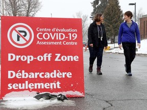 Nurse Lynn Rastelli from CHEO and nurse Robin Morash from the Ottawa Hospital pose for a photo outside the COVID-19 Assessment Centre in Ottawa Monday March 23, 2020.