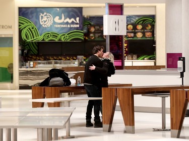 A very quiet Rideau Centre in Ottawa Thursday March 19, 2020. Almost all of the stores were shut down at  Rideau Centre due to the COVID-19 outbreak. A couple kiss in the empty food court Thursday.