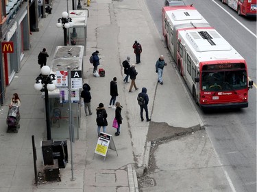 Getting on a bus on Rideau Street in Ottawa Thursday March 19, 2020. Almost all of the stores were shut down at  Rideau Centre due to the COVID-19 outbreak.