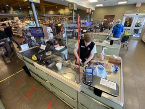 Plexiglas separating the cashier at Farm Boy In Ottawa from the customers. But not all store workers are getting this kind of protection.