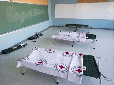 Cots set up in a former classroom, now a dormitory, as Mayor Jim Watson tours the isolation centre for vulnerable residents, ahead of its opening on Monday.