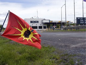 A Mohawk Warrior flag flies in front of the Canadian border crossing station near Akwesasne