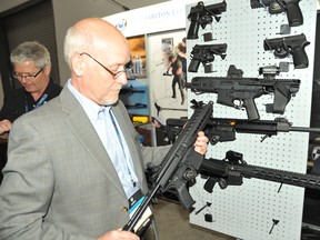 An exhibitor displays small arms for police and military at CANSEC 2018. David Pugliese photo.