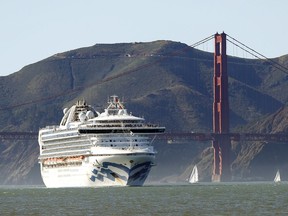 In this Feb. 11, 2020, file photo, the Grand Princess cruise ship passes the Golden Gate Bridge as it arrives from Hawaii in San Francisco. Scrambling to keep the coronavirus at bay, officials ordered the cruise ship to hold off the California coast Thursday, March 5, to await testing of those aboard, after a passenger on an earlier voyage died and at least one other became infected.
