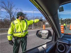 Québec officers stop vehicles entering Quebec on the Champlain Bridge as road blocks continue on the Ottawa River bridges by various Quebec authorities.