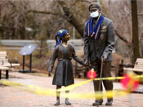 Photographer Julie Oliver captures the moment: 'As a stark reminder of how vulnerable the elderly are amidst the COVID-19 pandemic, a mask showed up on the statue at Manotick's Remembrance garden.'