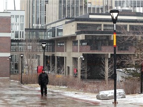 A solitary man walks through the normally busy campus at Carleton University.