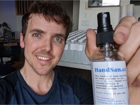 Jordan Harding shows one of the 500 or so bottles of free hand sanitizer he has bottled and delivered during the COVID-19 pandemic. Photo: Jordan Harding