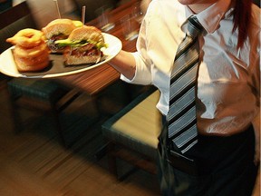 FILE: A server carries a try of food.