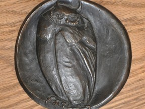 Bronze owl medal.