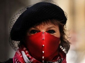 NEW YORK, NY - APRIL 02: Delphine Le Goff pauses as she takes a walk along an empty Wall Street on April 02, 2020 in New York City. Hospitals in New York City, which has been especially hard hit by the coronavirus, are facing shortages of beds, ventilators and protective equipment for medical staff. Currently, over 92,000 people in New York state have tested positive for COVID-19.