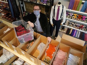 BERLIN, GERMANY - APRIL 21: Jan-Henrik Scheper-Stuke, managing director of Auerbach, a Berlin-based manufactory of luxury ties, scarves and suspenders, poses with boxes of Auerbach-produced protective face masks during the novel coronavirus crisis on April 21, 2020 in Berlin, Germany.