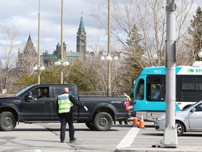 Gatineau police officers control the traffic leaving from and arriving into Gatineau to Ottawa on the Portage Bridge