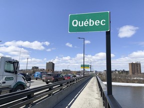 Sûreté du Québec stop vehicles on the Macdonald-Cartier Interprovincial Bridge as they entered Gatineau, Quebec from Ottawa, Ontario to check for drivers and passengers possibly infected with COVID-19 in April, 2020.