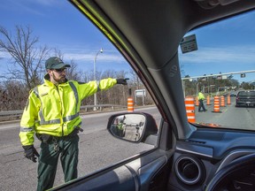 Contrôle routier Québec officers stop vehicles entering Quebec on the Champlain Bridge as road blocks continue on the Ottawa River bridges by various Quebec authorities.