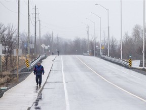 People walk along Jeanne D'Arc Blvd Sunday, April 5, 2020. ASHLEY FRASER, Postmedia