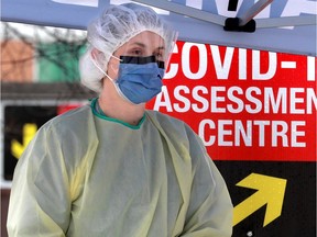 Nurses take COVID-19 swabs at a drive-thru testing site.
