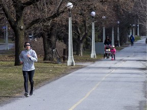 Pedestrians try for some fresh air along the Queen Elizabeth Driveway.