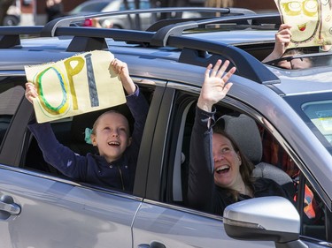 Family members waved from their cars as they passed in front of the City View Retirement Community building on Saturday. Wayne Cuddington, Postmedia