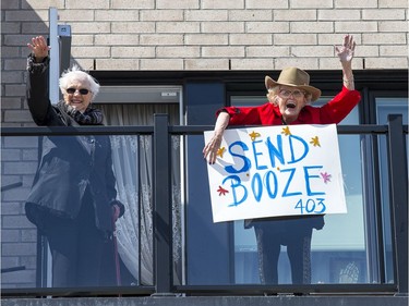 Residents Jean Stewart, left, and Annie Pomerleau enjoy a laugh with the sign Annie for the vehicle parade at the City View Retirement Community on Saturday. Wayne Cuddington, Postmedia