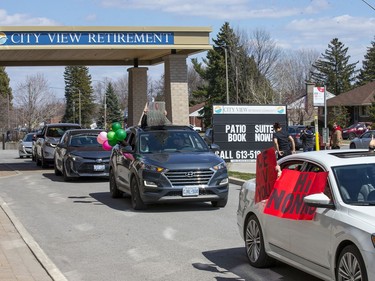 Families waved from their cars during the parade past the City View Retirement Community facility on Meadowlands Drive on Saturday. Wayne Cuddington, Postmedia