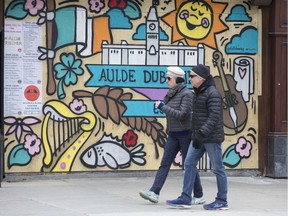 April 24, 2020.  Muralist Robbie Lariviere, who goes by the artist name "Falldown", is working on a number of Byward Market businesses including The Aulde Dubliner (seen here) and the Heart and Crown to help spruce up the ugly boarded up windows and to let customers know that the businesses will be open again whenever the pandemic allows them.