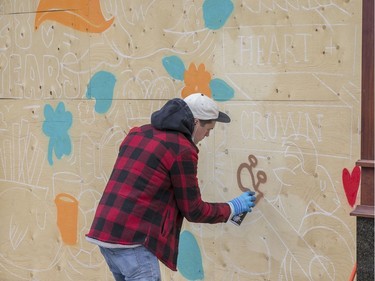 Muralist Robbie Lariviere, who goes by the artist name "Falldown", is working on a number of Byward Market businesses including The Aulde Dubliner and the Heart and Crown (seen here) to help spruce up the ugly boarded up windows and to let customers know that the businesses will be open again whenever the pandemic allows them.