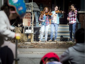 Performing outside their Old Ottawa South home on Saturday morning were the Sugars-Keen sisters, left to right, Neve, 19, Abbey, 17, and Morgan, 14.