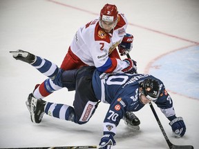 Russia's defender Artyom Zub (left) fights for the puck with Finland's forward Teemu Hartikainen during the Channel One Cup of the Euro Hockey Tour ice hockey match between Russia and Finland in Moscow on December 17, 2017.