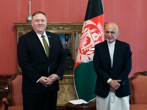 FILE: March 23, 2020, Afghanistan's President Ashraf Ghani poses for a picture with US Secretary of State Mike Pompeo (L) during their meeting in Kabul. (Photo by - Press Office of President of Afghanistan / AFP)