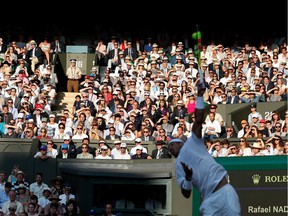 (FILES) In this file photo taken on July 12, 2019 The crowd watches as Spain's Rafael Nadal returns against Switzerland's Roger Federer during their men's singles semi-final match on day 11 of the 2019 Wimbledon Championships at The All England Lawn Tennis Club in Wimbledon, southwest London, on July 12, 2019. - The 2020 Wimbledon Championships has been cancelled for the first time since World War II due to the coronavirus pandemic, the organisers said in a statement on April 1, 2020, as the virus wreaks further havoc on the global sporting calendar.