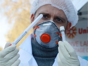 A biologist shows a sample to detect the virus.
