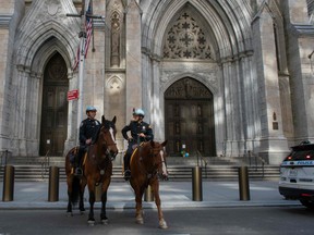Members of the New York City Police Department (NYPD) Mounted Police Units patrol outside the St. Patrick's Cathedral while Cardinal Timothy Dolan celebrates Easter Mass amid the Coronavirus pandemic on April 12, 2020 in New York City.