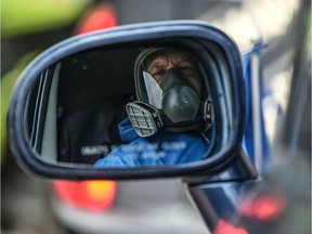 A cemetery worker wears protective suits as a preventive measure against the spread of the new coronavirus, COVID-19, in Bogota on April 10, 2020.