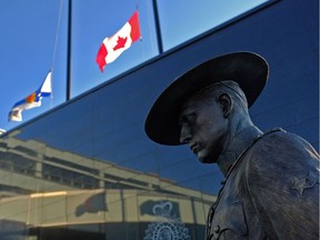 Flags of Nova Scotia and Canada fly at half-staff outside the Nova Scotia Royal Canadian Mounted Police (RCMP) headquarters in Dartmouth, Nova Scotia, Canada, on April 19, 2020, after a shooting rampage left at least 16 dead