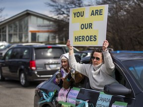 A parade of cars bearing positive messages drives in front of a long-term care centre in the Toronto area.