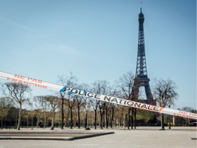 A police cordon blocks access to the Champs de Mars park near the Eiffel Tower monument in Paris, France.