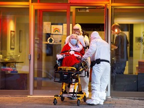 Ambulance attendants take a resident out of Floralies Lasalle, a seniors' residence, amid an outbreak of the coronavirus disease (COVID-19), in Montreal, Quebec, Canada April 14, 2020. REUTERS/Christinne Muschi ORG XMIT: GGG-MON113