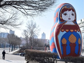 A man walks past a giant statue of a Russian Matryoshka doll on a street in Suifenhe, a city of Heilongjiang province on the border with Russia, as the spread of the novel coronavirus disease (COVID-19) continues in the country, China April 12, 2020. REUTERS/Huizhong Wu ORG XMIT: PPP-PEK05