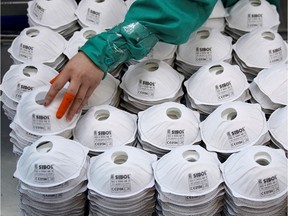 Masks are seen on a production line manufacturing masks at a factory in Shanghai, China on Jan. 31, 2020.
