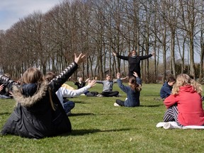Rebekka Hjorth holds a music lesson outdoors with her class at the Korshoejskolen school, after it reopened following the lockdown due to the coronavirus pandemic, in Randers, Denmark, April 15, 2020.